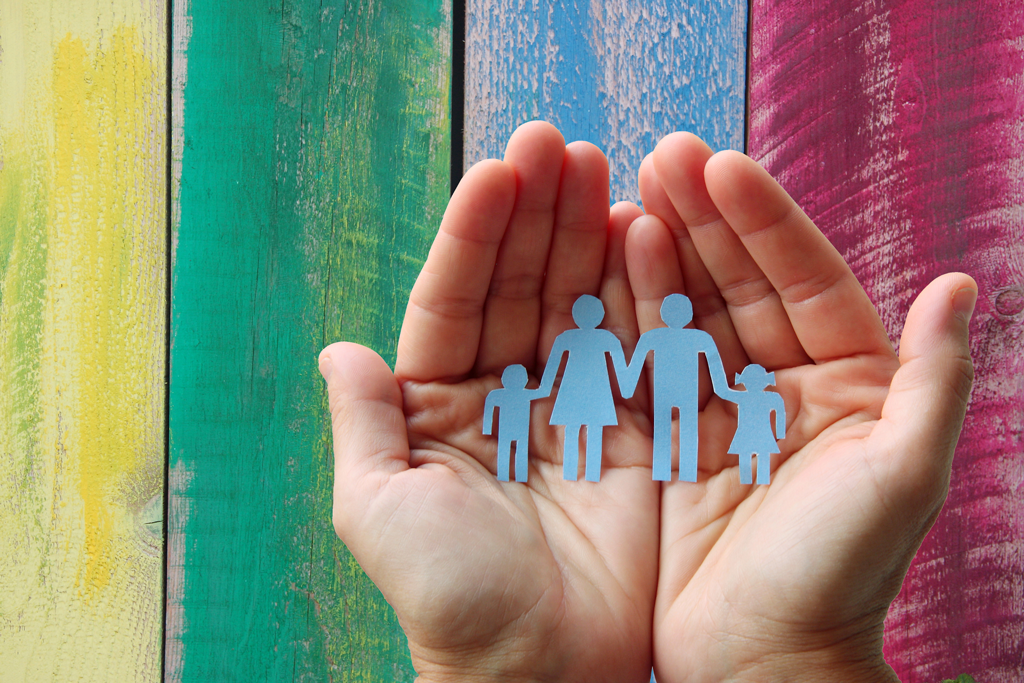 hands holding paper family