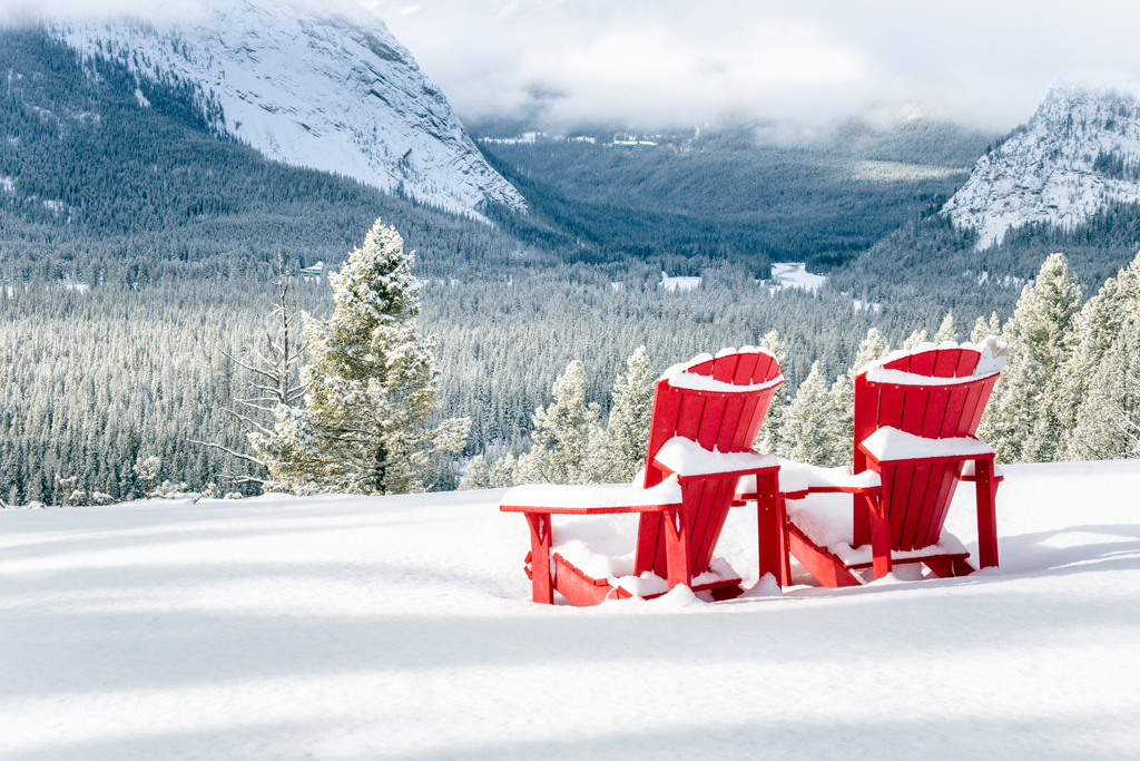 red adirondack chairs in the snow