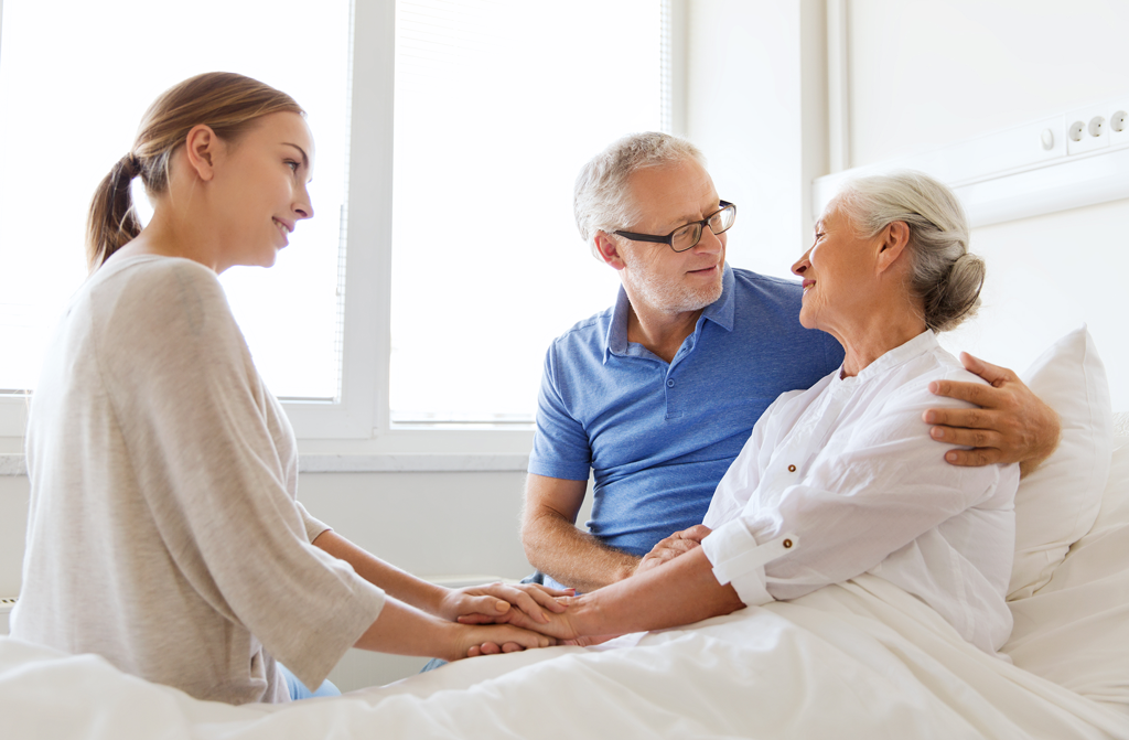 Daughter visiting mother in hospital with father