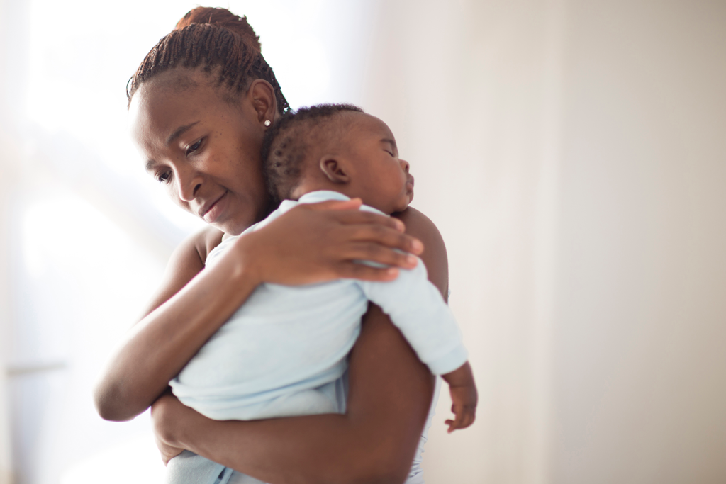 MOTHER HOLDING NEWBORN BABY