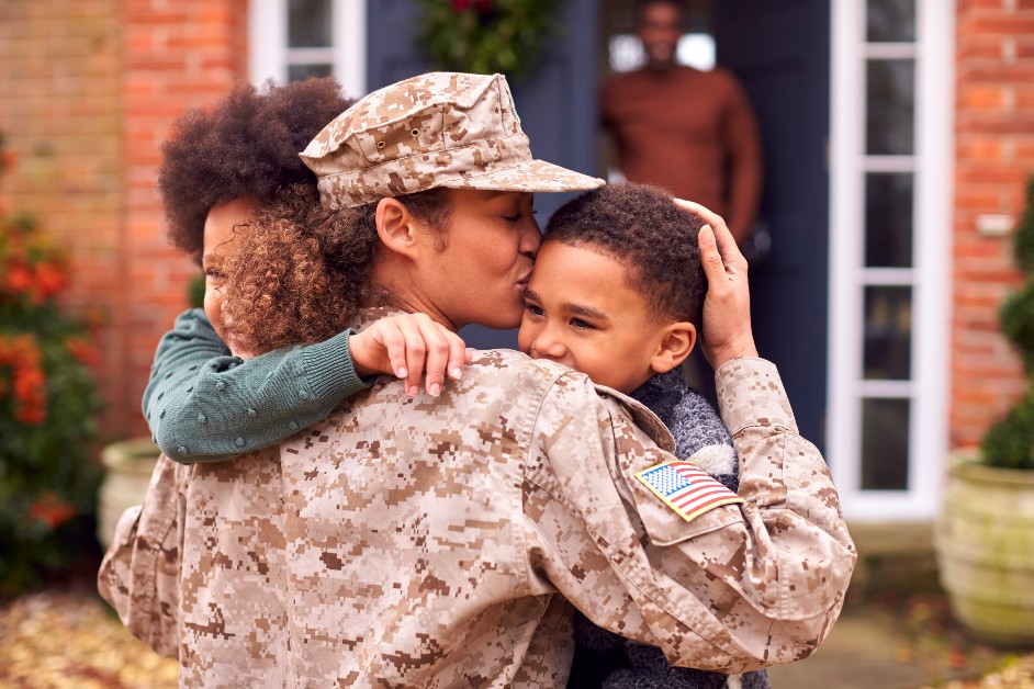 Female military employee hugging children