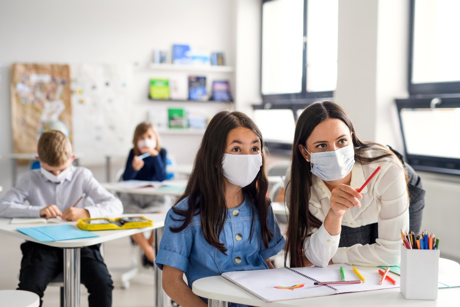 Child and teacher during COVID-19 pandemic