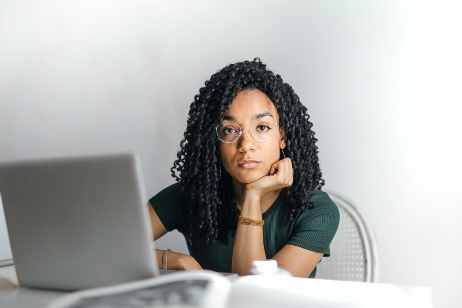 Woman behind laptop researching FFCRA