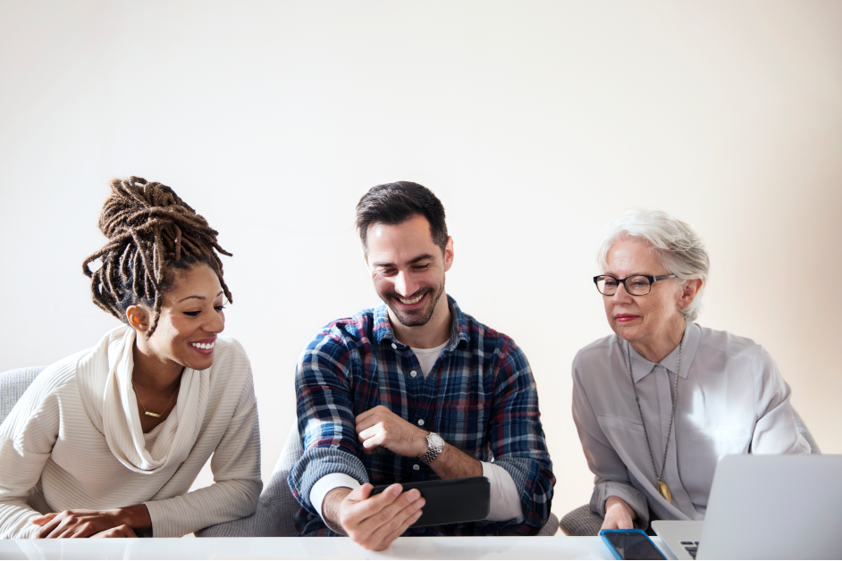 diverse team looking at phone
