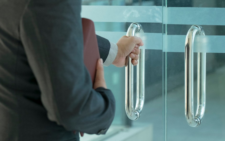 Person opening door into a business location
