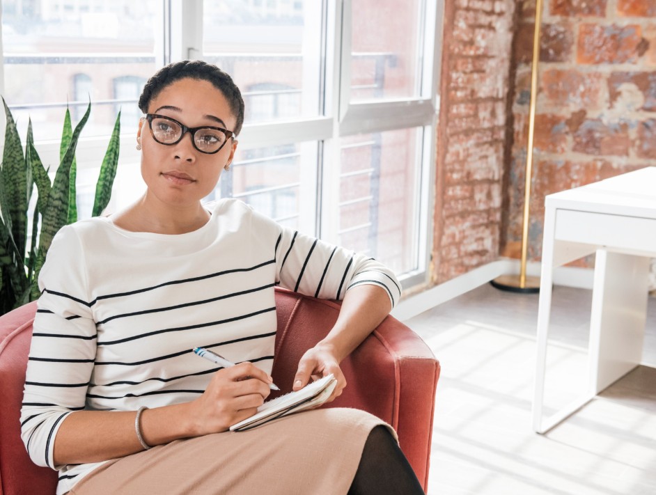 Woman listening and making notes