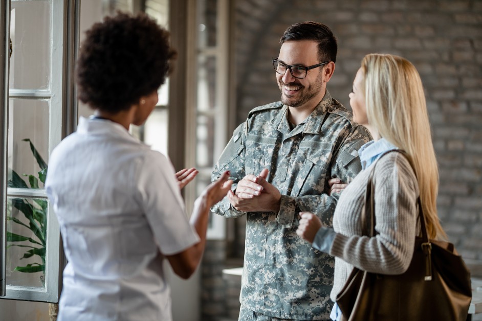 Military member with wife speaking with employer